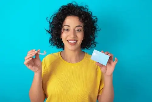 woman with invisalign and credit card